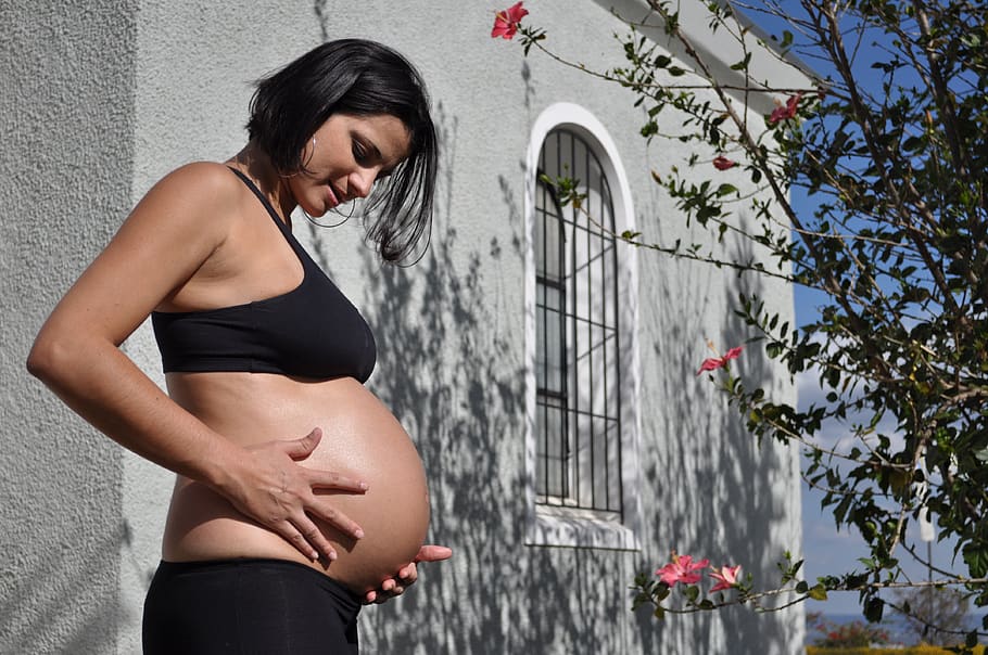 pregnant woman pregnant big belly future mother hands summer