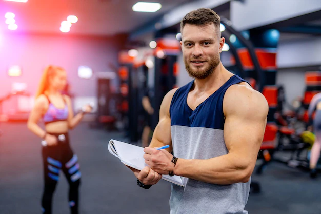 fitness trainer is writing clipboard muscular coach give advice woman man creating workout plan woman 116317 10046
